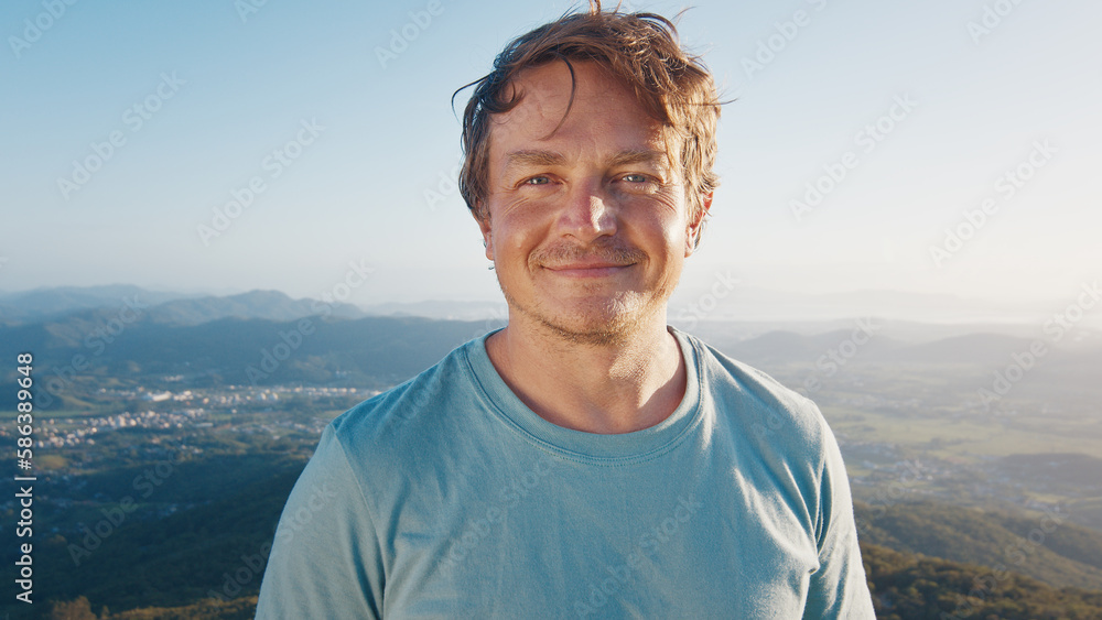 Portrait of the young happy smiling man. Young caucasian man outdoor at sunrise Portrait of the young happy smiling man. Young caucasian man outdoor at sunrise