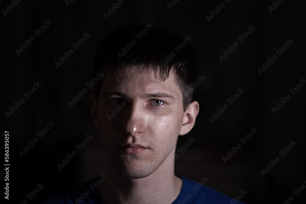 portrait of a young man on a dark background