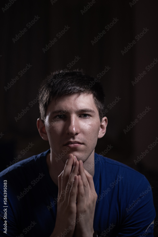 portrait of a young man on a dark background portrait of a young man on a dark background