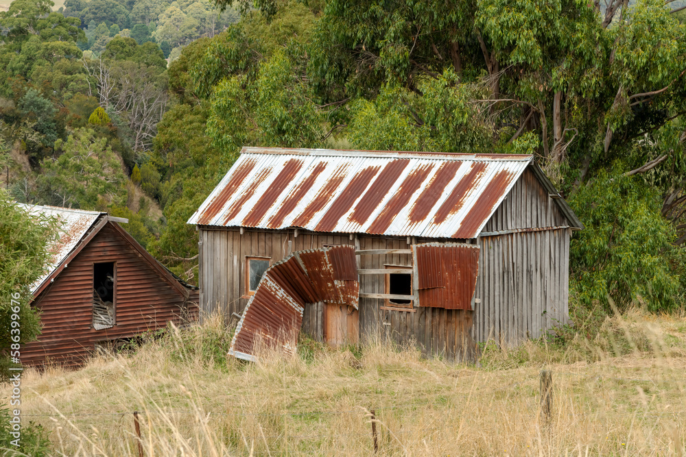Old rusty derelict sheds made from sheets of corrugated iron in rural Tasmania, Australia. Old rusty derelict sheds made from sheets of corrugated iron in rural Tasmania, Australia.
