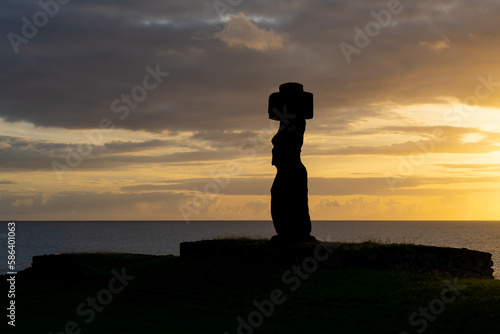 Side view of the moai of Ahu Ko Te Riku with headgear (pukao) and eyes at dusk on Easter Island (Rapa Nui), Chile. The moai of Ahu Ko Te Riku is the only complete moai on Easter Island. photo