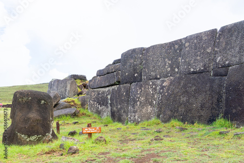 Easter Island, Chile - February 28, 2023:  Wall of the ahu Tahira and  Moai head  in Vinapu Archaeological Complex, Easter Island (Rapa Nui), Chile photo