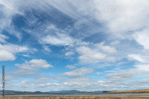 Blue and white wispy sky landscape in Tasmania.