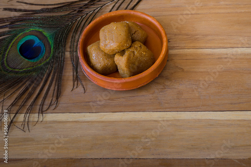 Billede på lærred Mathura ka peda is served on a clay plate with peacock feather during celebration of Krishna janmashtami