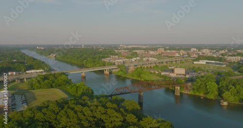 Aerial Forward Shot Of Black Warrior Railroad Bridge By Famous Stadium In City On Sunny Day - Tuscaloosa, Alabama photo