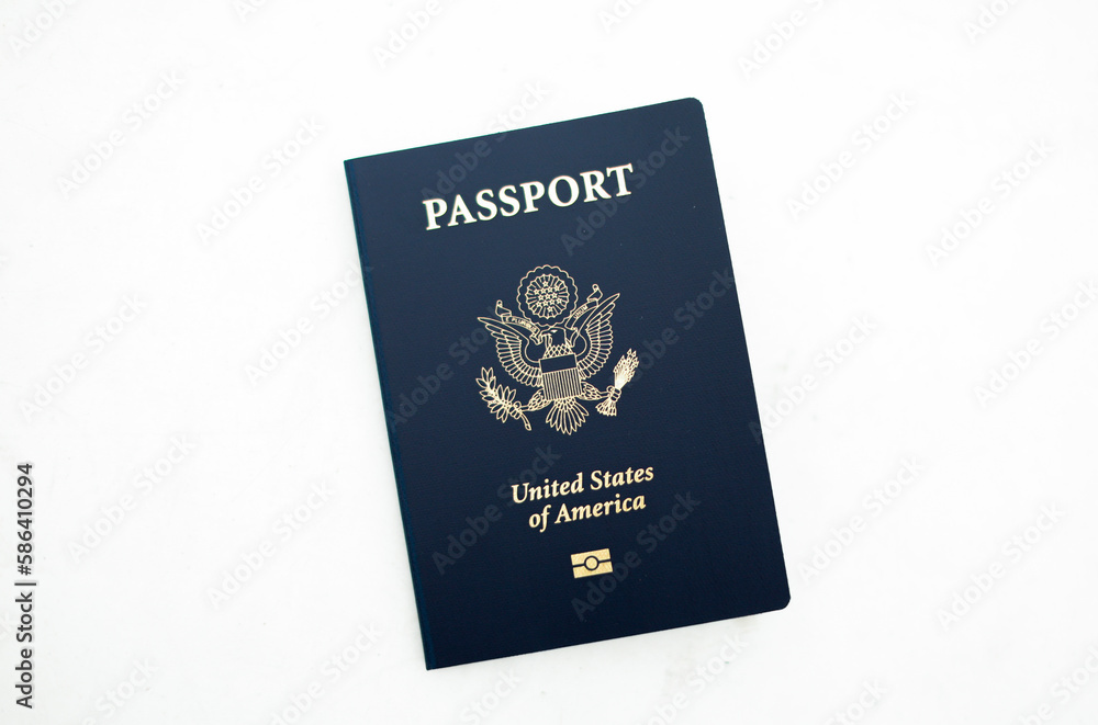 Close-up of a US passport with immigration, visa, citizenship, and travel paperwork on a wooden table Close-up of a US passport with immigration, visa, citizenship, and travel paperwork on a wooden table