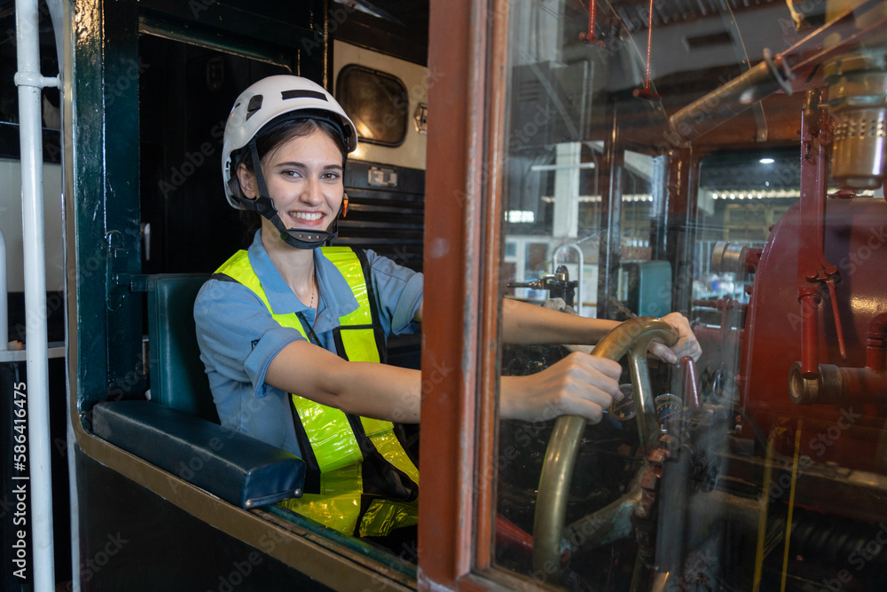 Portrait of Engineer train Inspect the train's diesel engine, railway track in depot of train
