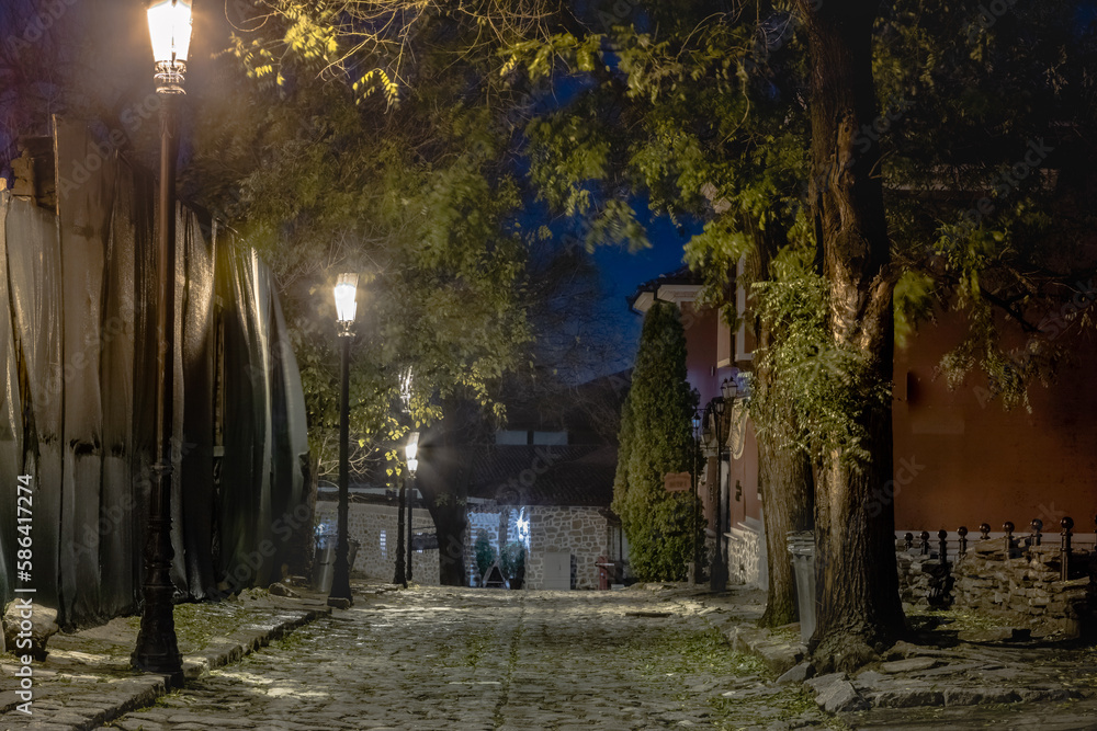 Dark and mysterious alley illuminated at night in Plovdiv, Bulgaria