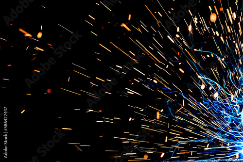 Close up view and background of the gas metal arc welding (GMAW) process with sparks, light, bokeh effect and smoke.