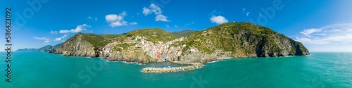 Fototapeta Naklejka Na Ścianę i Meble -  Aerial panorama top view of Riomaggiore colorful fishing village one of the five Cinque Terre Villages in national park, sequence of hill cities along the coastline of Ligurian Sea in Italy. 