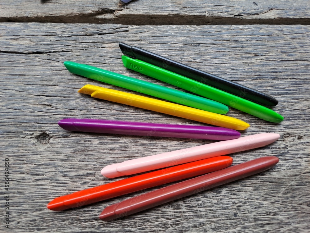 Multicolored crayons . Crayons and pastels lined up isolated on wood background. Multicolored crayons . Crayons and pastels lined up isolated on wood background.