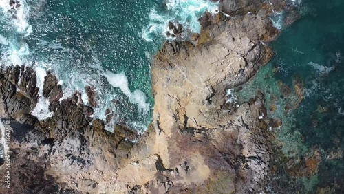 cliffs and rocks with waves in the coast of the pacific ocean in america, panoramic view with a drone summer landscape
