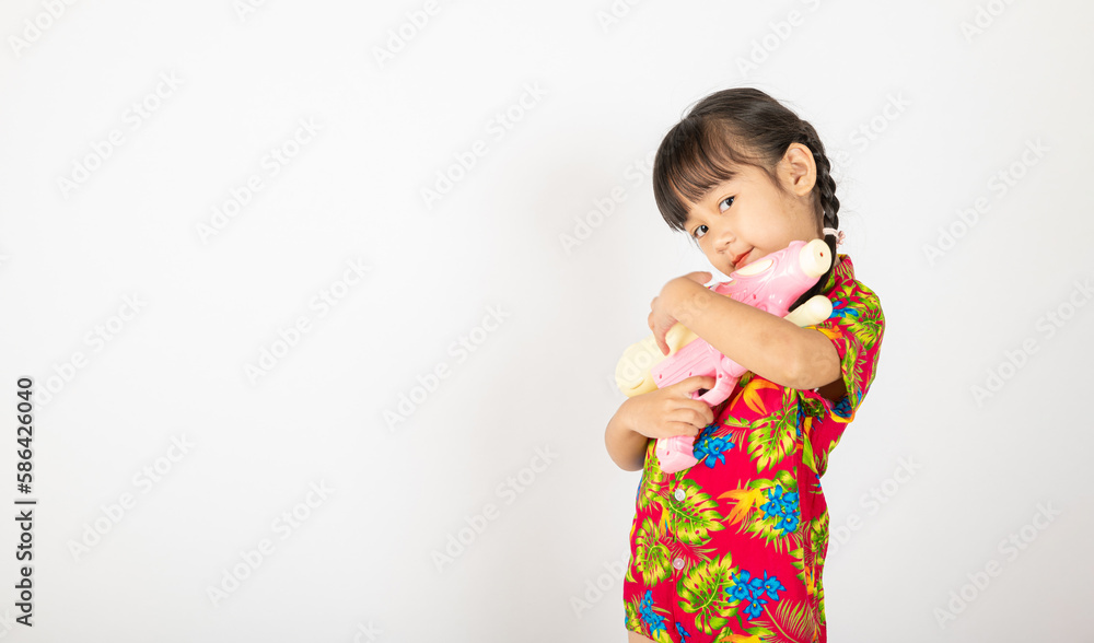 Happy Songkran Day, Asian kid girl with floral shirt hold water gun, Thai child funny hold toy water pistol and smile, isolated on white background, Thailand Songkran festival national culture concept Happy Songkran Day, Asian kid girl with floral shirt hold water gun, Thai child funny hold toy water pistol and smile, isolated on white background, Thailand Songkran festival national culture concept