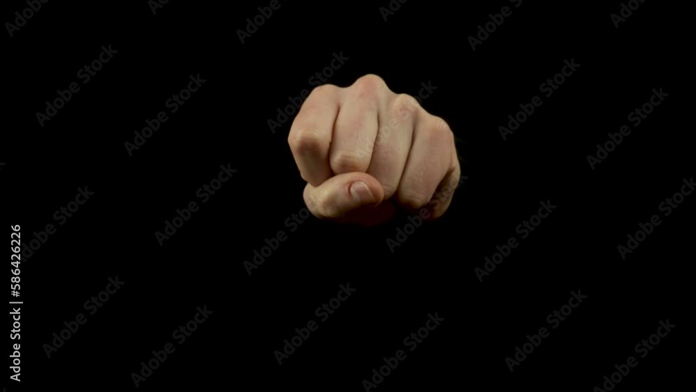 Static shot of a man showing a disappearing coin trick against a black background Static shot of a man showing a disappearing coin trick against a black background