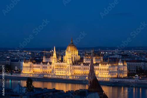 Budapest parliament illuminated at night and Danube river  Hungary