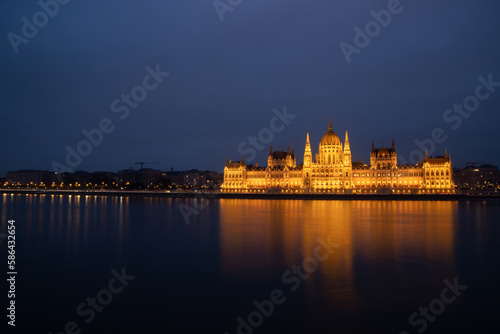 Budapest parliament illuminated at night and Danube river, Hungary