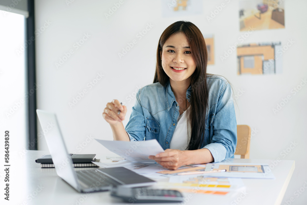Woman architect holding pencil to sketching and designing buildi Woman architect holding pencil to sketching and designing buildi