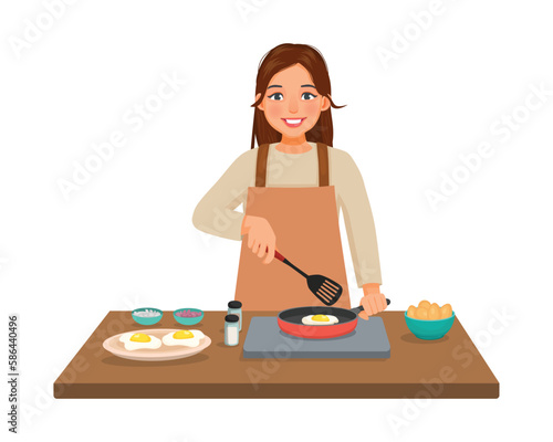 Young woman cooking fried egg with frying pan in the kitchen