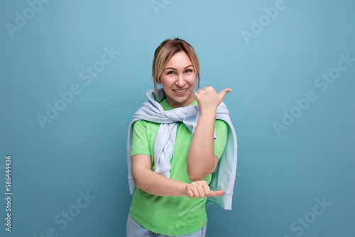 banner portrait of a positive bright girl in a casual outfit on a blue background with copy space