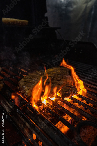 Beef steak on the grill with flames