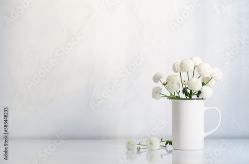 Fototapeta Naklejka Na Ścianę i Meble -  white chrysanthemums in vintage cup on white background