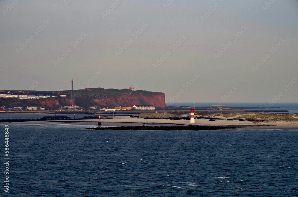 Helgoland island in North Sea with red cliffs during sunset twilight blue hour seen from outdoor deck of cruiseship cruise ship liner