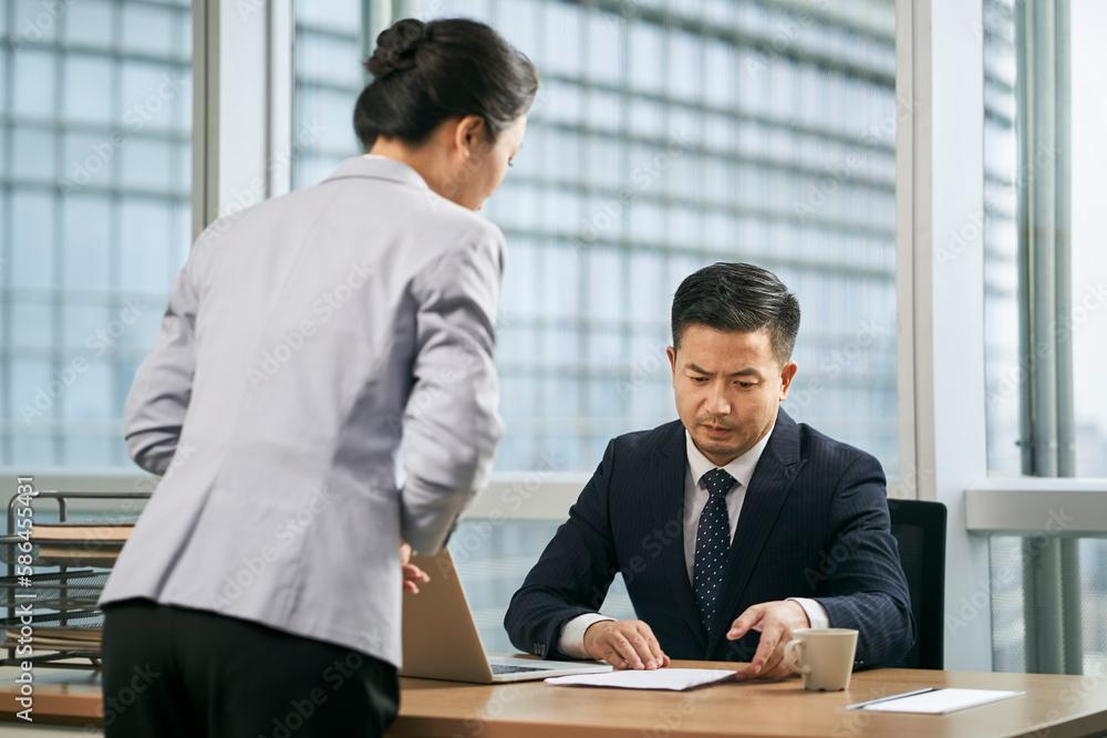 asian business manager reviewing report in office asian business manager reviewing report in office