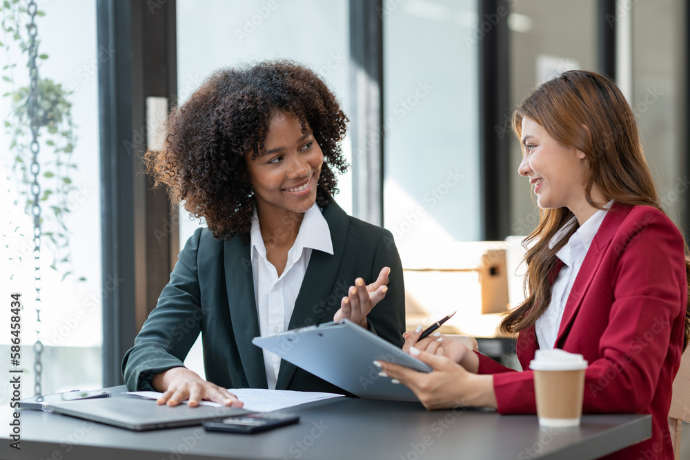 Young Asian and African businesswoman Africans brainstorming on real estate projects. investment plan Financial business together in the office management concept management. Young Asian and African businesswoman Africans brainstorming on real estate projects. investment plan Financial business together in the office management concept management.
