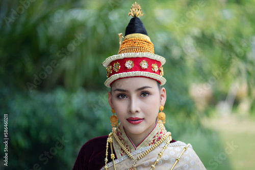 Pretty young Asian woman dressed elegantly in dress Luang Prabang Laos style for the Songkran Festival is the national tradition of Thailand and in Vientiane Laos at Chiang Mai Thailand.