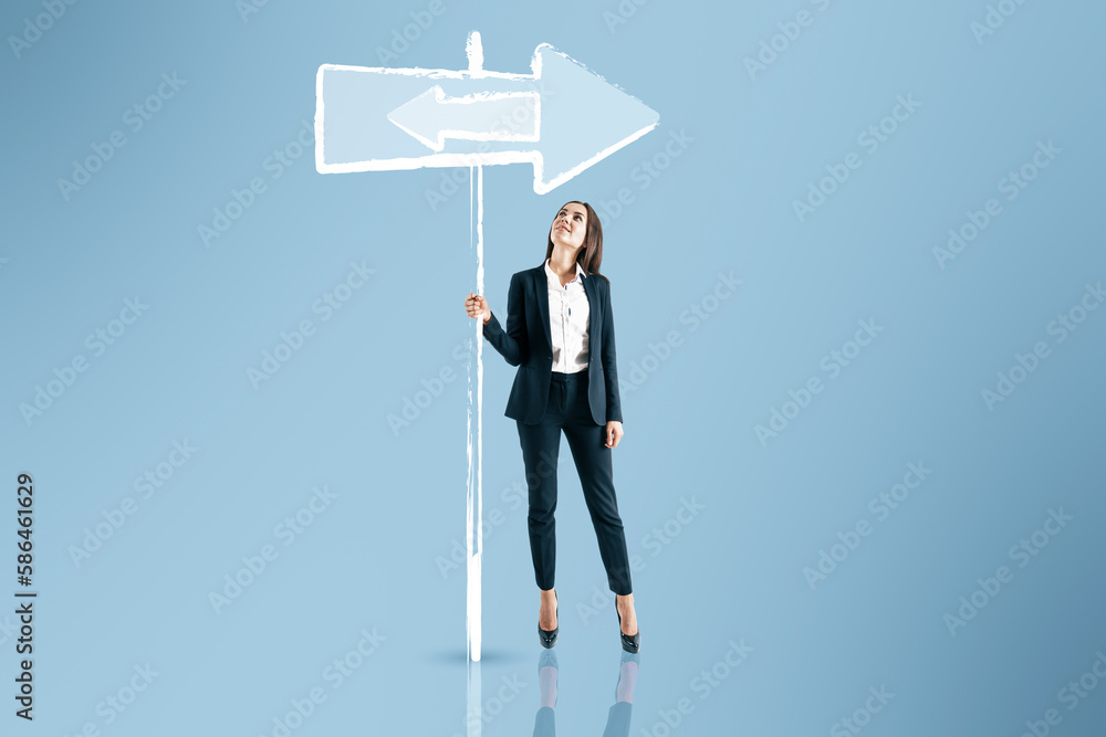 Young european woman thinking which path to choose on blue background with sign sketch. Different direction concept. Young european woman thinking which path to choose on blue background with sign sketch. Different direction concept.