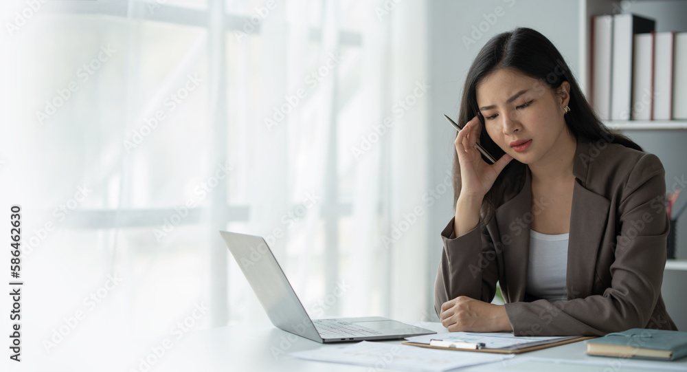 copy space , panorama , banner ,tired business woman sleepy and bored from sitting at a desk for a long time and has office syndrome copy space , panorama , banner ,tired business woman sleepy and bored from sitting at a desk for a long time and has office syndrome