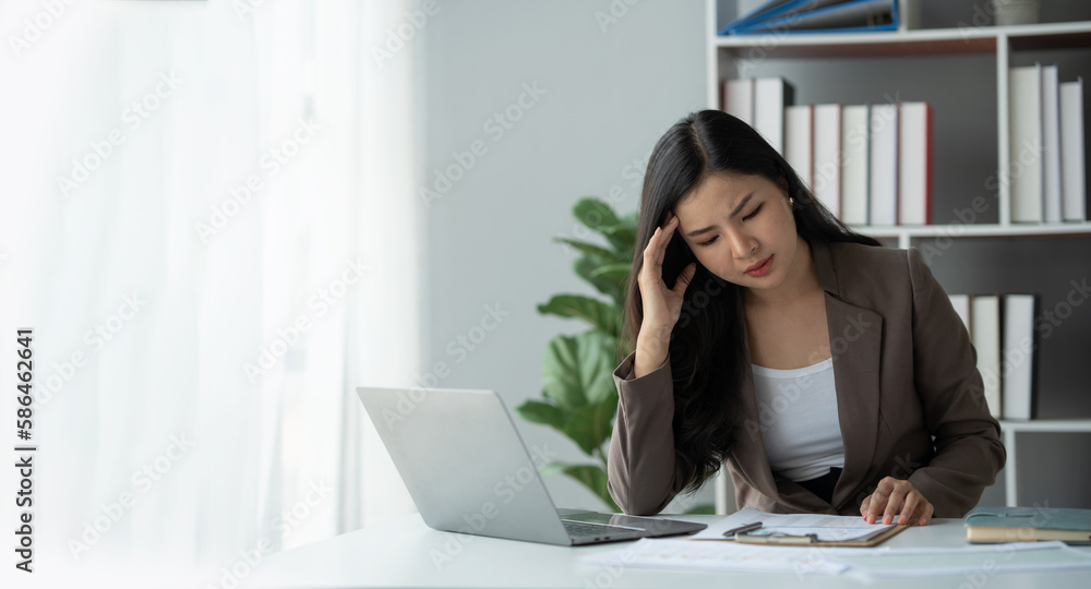copy space , panorama , banner ,tired business woman sleepy and bored from sitting at a desk for a long time and has office syndrome copy space , panorama , banner ,tired business woman sleepy and bored from sitting at a desk for a long time and has office syndrome