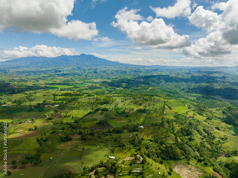 Fototapeta premium Aerial view of farmland in a valley in a mountainous province. Negros, Philippines