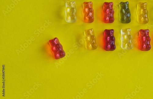 delicious multi-colored jelly beans on a yellow background