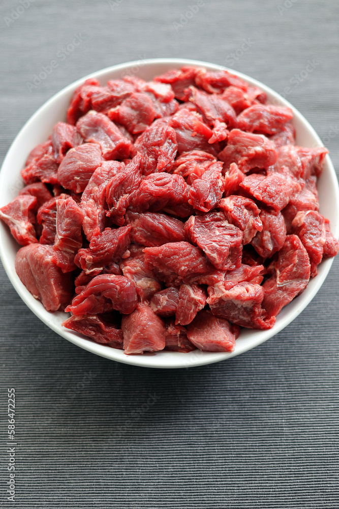 Fresh, raw beef cut into pieces, prepared for goulash Fresh, raw beef cut into pieces, prepared for goulash