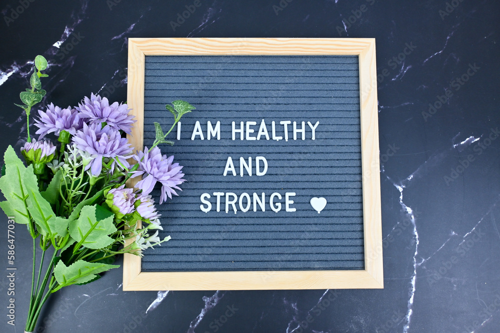Grey letter board with phrase Self care, I am healthy and strong. Self