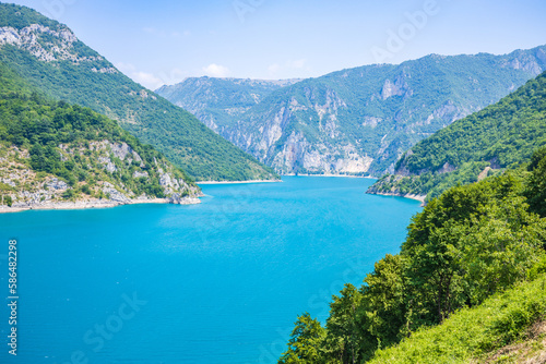 Landscape view of big lake between mountains at summer day © skumer