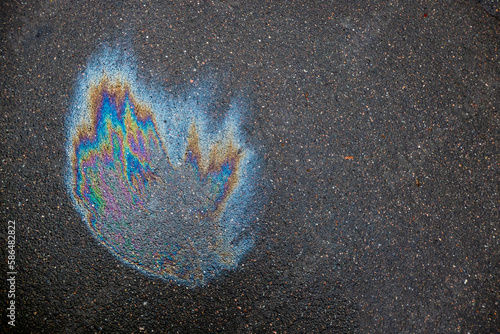 Quadro em tela Oil slick looks like a fire on the asphalt road background