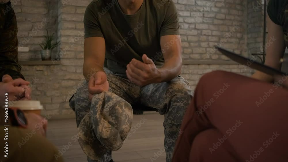 Close up of veterans hands holding hat during PTSD support group. Close up of veterans hands holding hat during PTSD support group.