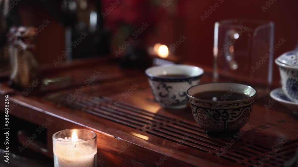 hot cup of tea stands on board for holding traditional Chinese tea ceremony, close-up hot cup of tea stands on board for holding traditional Chinese tea ceremony, close-up