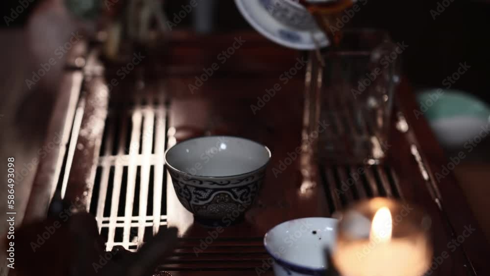 tea drinking, female master conducts a tea ceremony and pours a hot drink into bowls while sitting at a table, close-up tea drinking, female master conducts a tea ceremony and pours a hot drink into bowls while sitting at a table, close-up