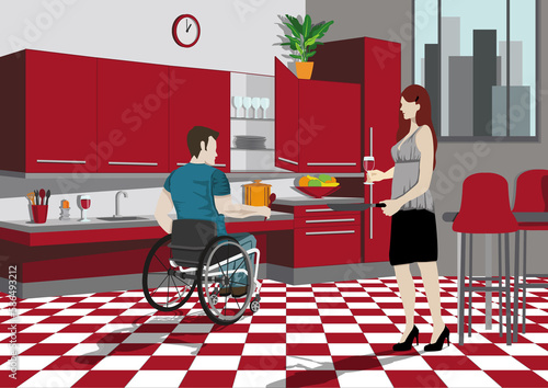 Un couple faisant la cuisine. Un homme handicapé faisant la cuisine chez lui avec un mobilier adapté à son handicap. photo