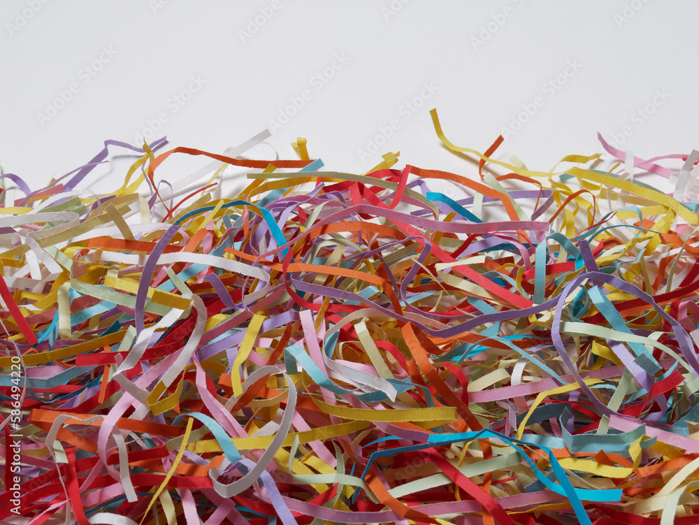 Colored shredded papers and white copy space Colored shredded papers and white copy space