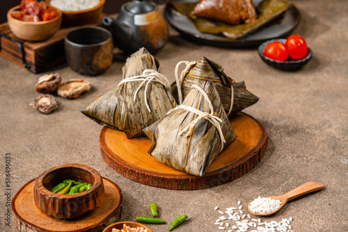 Zongzi is a traditional Chinese food made of glutinous rice stuffed with different fillings and wrapped in bamboo reed, or other large flat leaves. They are cooked by steaming or boiling.