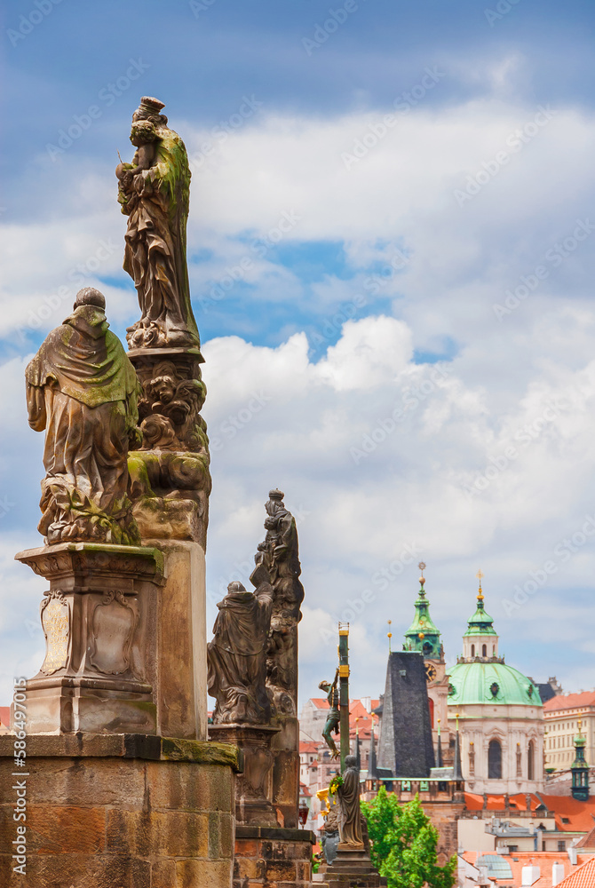 Charles Bridge beautiful 18th century baroque statues with Mala Strana Bridge Tower and St Nicholas Church