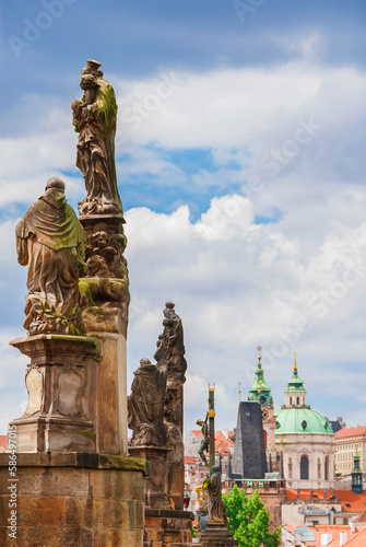 Charles Bridge beautiful 18th century baroque statues with Mala Strana Bridge Tower and St Nicholas Church photo