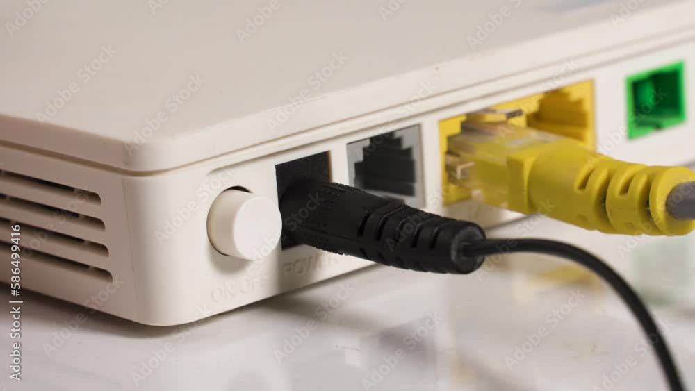 Man hand switch power button on internet router close-up Man hand switch power button on internet router close-up