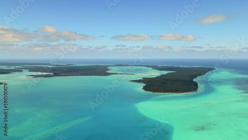 Aerial establishing view panning over Saint Maurice Bay, Kotomo Island, Isle of Pines. photo