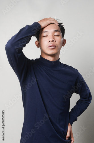 Young Man Wearing Blue Blank Turtleneck Shirt Posing Isolated Background © herukru