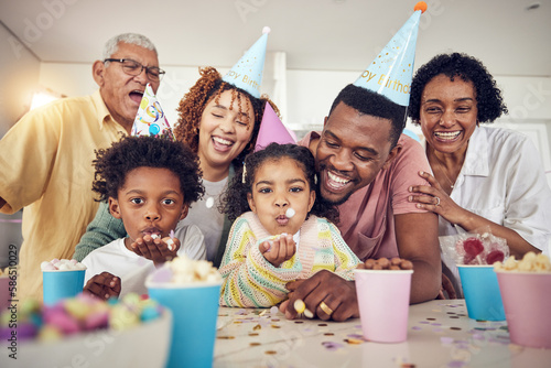Birthday party  blow and confetti with family in kitchen for celebration  bonding and affectionate. Happy  excited and grandparents with parents and children at home for surprise  fun or event